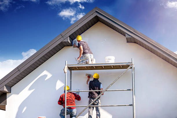 Stucco worker finishing exterior wall